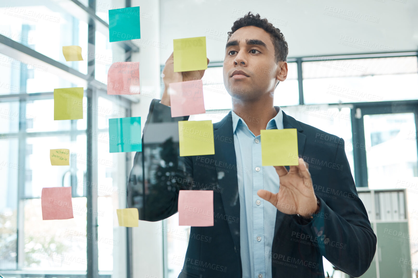 Buy stock photo Businessman, writing and schedule with glass board for brainstorming, planning or tasks at office. Young man, employee or planner with sticky note for reminder, agenda or workflow at workplace