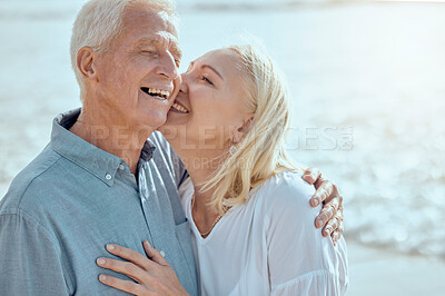 Buy stock photo Senior, couple and hug on beach with love on retirement vacation, romance and together with kiss for commitment. Man, woman and affection by ocean on summer holiday, happy and bonding with embrace.