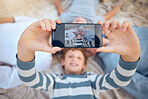 Happy caucasian grandparents lying with grandsons on a beach. Adorable, happy, children bonding with grandmother and grandfather in a garden or park outside. Family taking selfies together