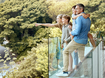 Buy stock photo Happy, family and and pointing on balcony, parents and bonding with children, smile and love in home. Outdoor, mom and dad with kids, hand and glasses for man, summer and woman in property and house