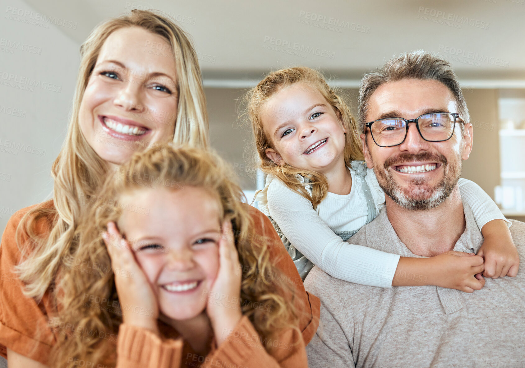 Buy stock photo Happy family, mother and portrait of father with kids in home lounge for care, love or hug for support. Face, parents and girls smile for laugh, embrace and connection with sisters bonding together