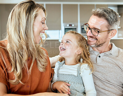 Buy stock photo Home, parents and daughter in living room, smile and bonding with conversation, girl and family on couch. Lounge, talking and relax with child, father and mom in house, glasses and love for kid