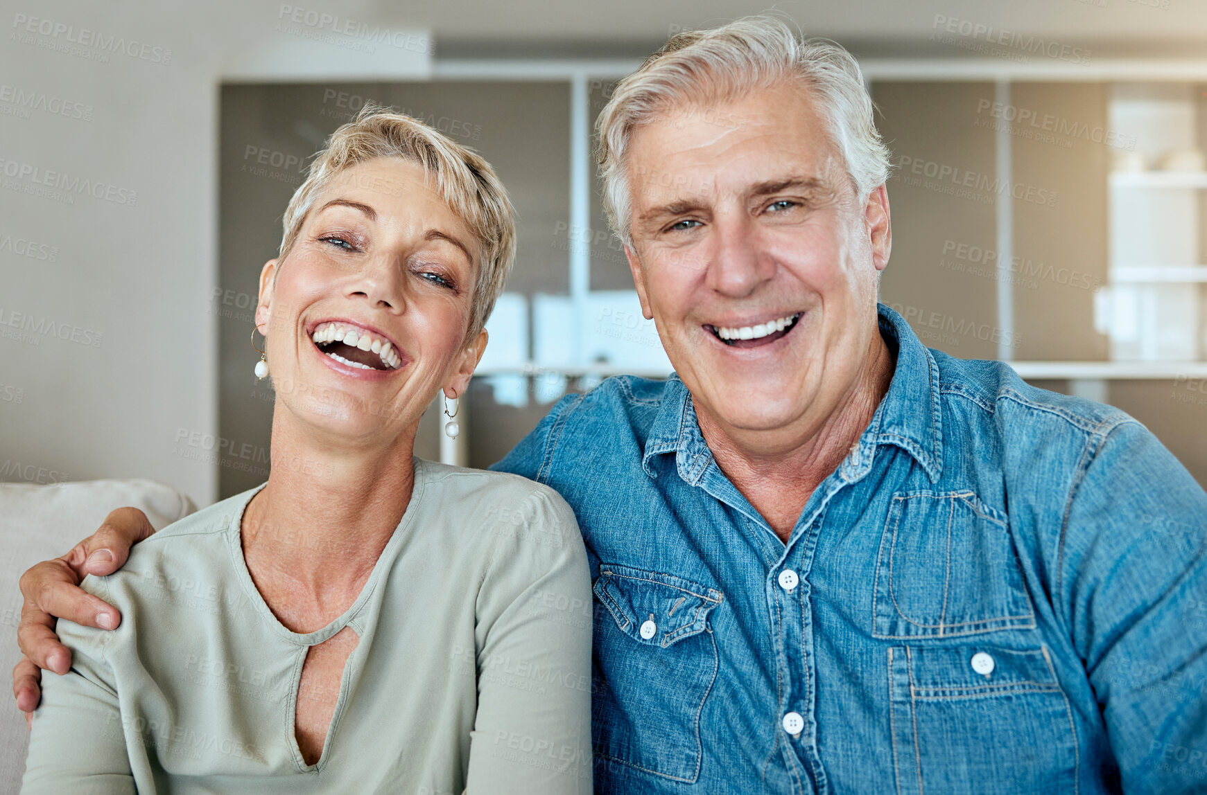 Buy stock photo Retirement, laugh and couple in lounge for relax, together and love in living room or home. Happy man, woman and joke or humor in house for support trust and communication for health and wellness