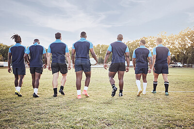 Buy stock photo Rugby, team and walking on field for competition, match or sport training on lawn. Athlete back, professional and group with workout, fitness and exercise for game practice at club for wellness