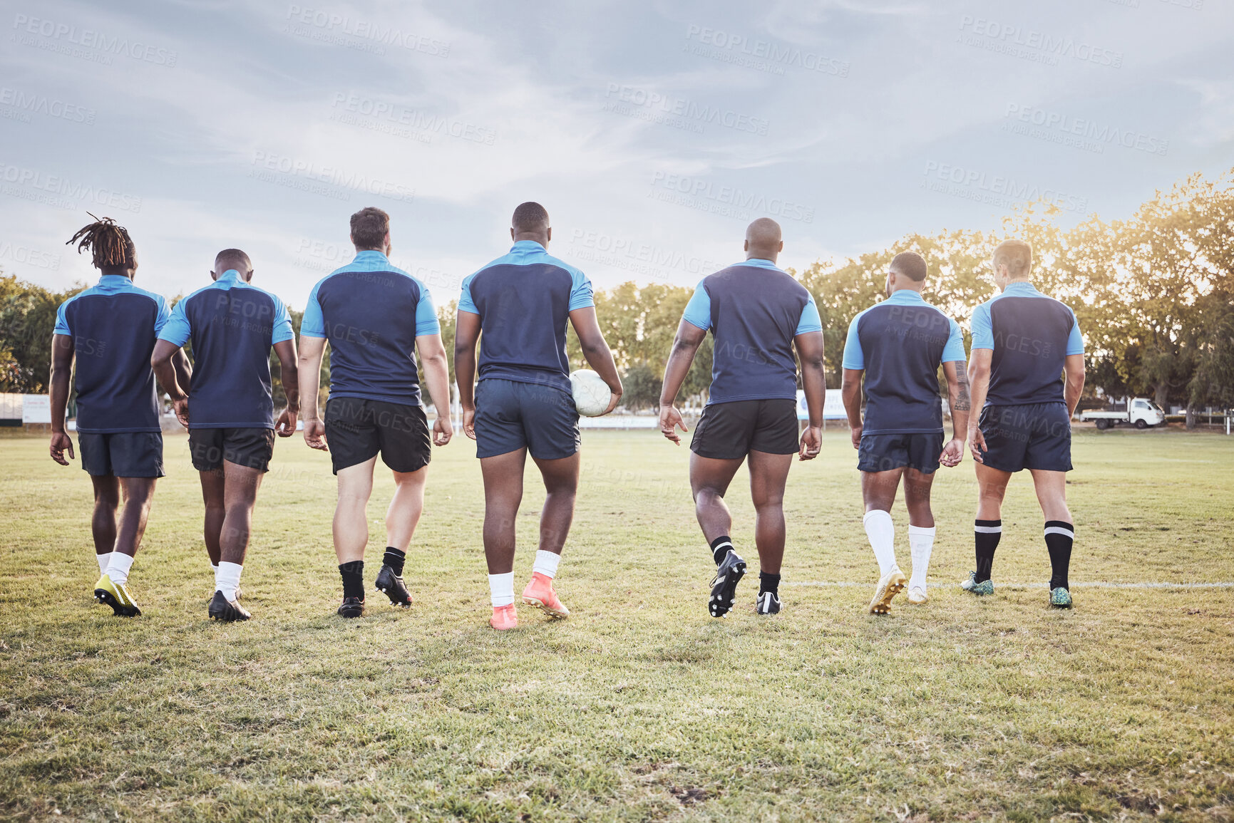 Buy stock photo Rugby, team and walking on field for competition, match or sport training on lawn. Athlete back, professional and group with workout, fitness and exercise for game practice at club for wellness