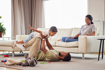 Buy stock photo Home, parents and child with airplane on floor for balance, freedom and bonding together in childhood. Happy, father and son with game by toys in living room for love, care and imagination of flight