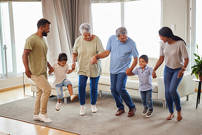 Buy stock photo Family, dance and bonding in living room while holding hands for fun, support or people playing game. Grandparents, parents and children in home for birthday party, celebration and freedom with music