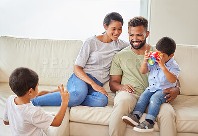 Buy stock photo Happy family, parents and children with toy camera for picture, peace sign or bonding together on sofa. Mother, father and brothers play in home living room for game, love and care with photo of kids