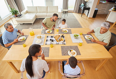 Buy stock photo Happy family, dinner and eating food at table together for holiday celebration, bonding and sharing a meal. People, parents and grandparents with kids in home for lunch, social gathering and top view