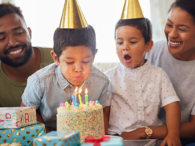 Buy stock photo Family, blowing and boy with cake for birthday party, support and people at fun event in house on sofa. Parents, happiness and children for growth, celebration and happy with gift in living room