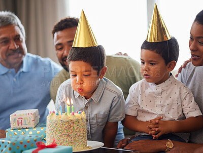 Buy stock photo Family, boy and birthday cake with blowing on sofa for bonding, support and people at fun home event. Grandparents, parents and children for growth, celebration and party with gift in living room