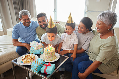 Buy stock photo Family, cake and birthday party with candles on sofa for bonding, support and people at fun home event. Grandparents, parents and children for growth, celebration and happy with gift in living room