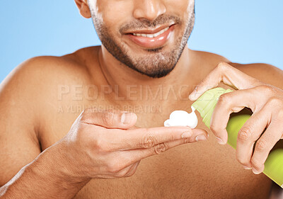 Buy stock photo Hand, shaving cream and man in studio for skincare, beauty and hair care against a blue background with mockup. Hands, foam and face hair grooming with model cleaning, hygiene and skin care product