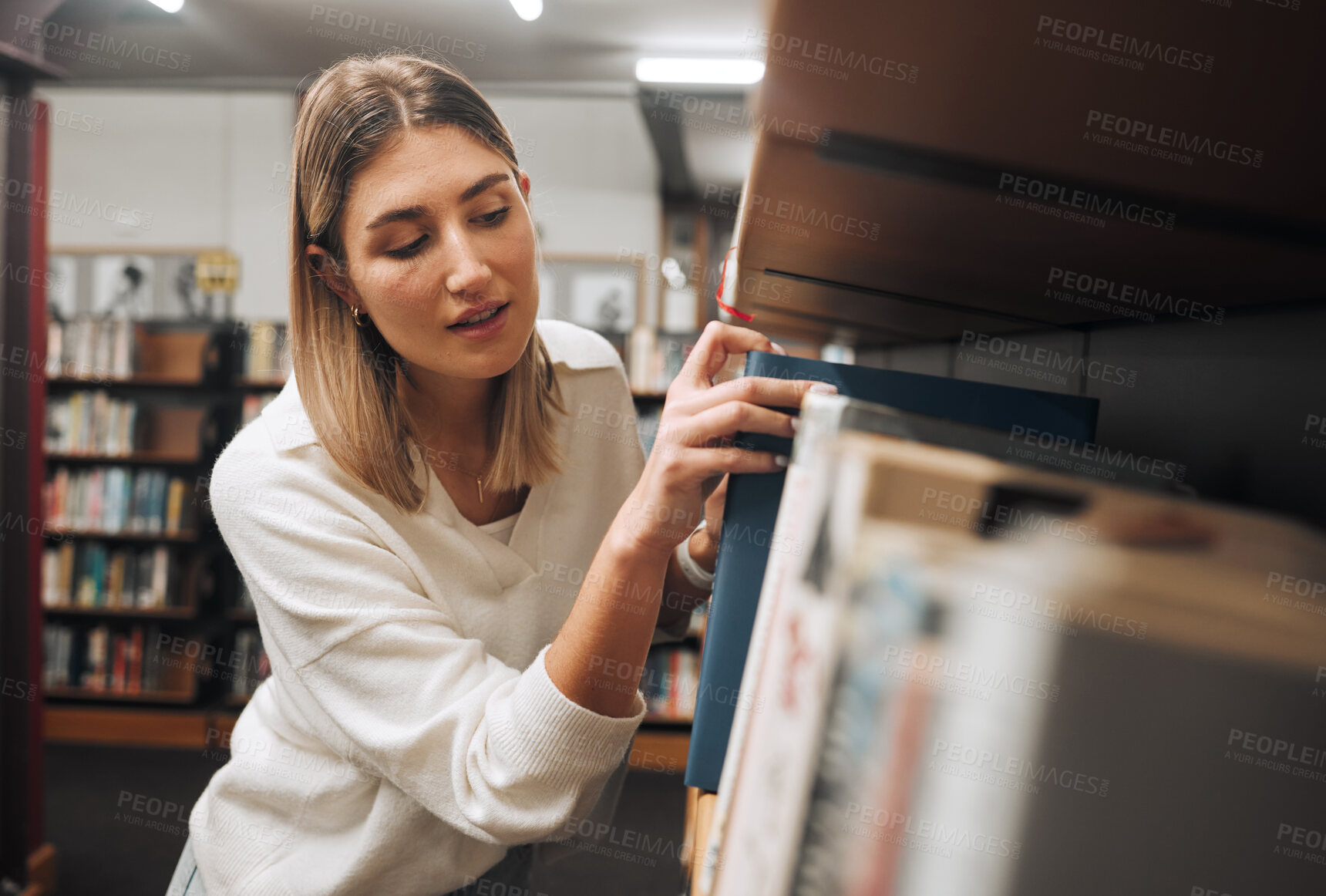 Buy stock photo Girl, student and search books in library for education, knowledge and learning. Young woman, university student and bookshelf at college campus for reading, studying and literature research analysis