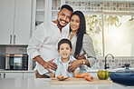 Kitchen, family and portrait of mother, father and young child together cooking with happiness. Happy, smile and parent love of children in a house making food for dinner ready for eating at home