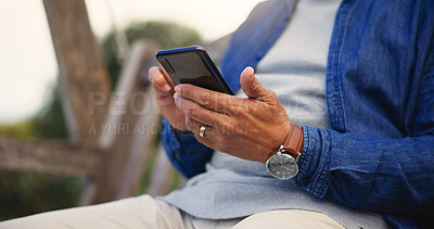 Buy stock photo Phone, hands and closeup of senior man networking on social media. mobile app or the internet. Technology, cellphone and elderly male person in retirement scroll on website outdoor in park or garden.