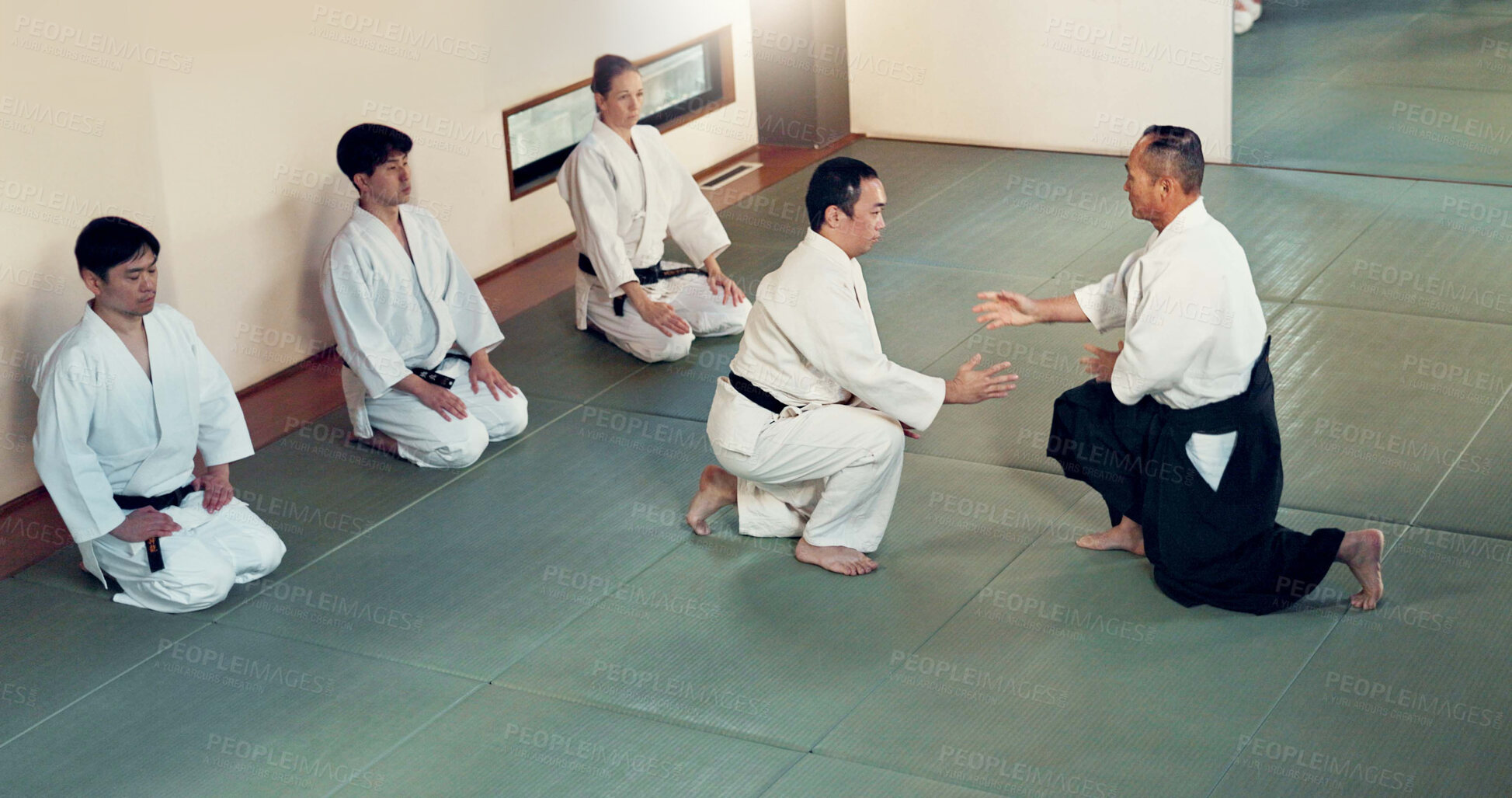 Buy stock photo Aikido, class and fight with a master in martial arts with student in self defence, discipline and training. Technique, demonstration or Japanese sensei with black belt skill in fighting or education