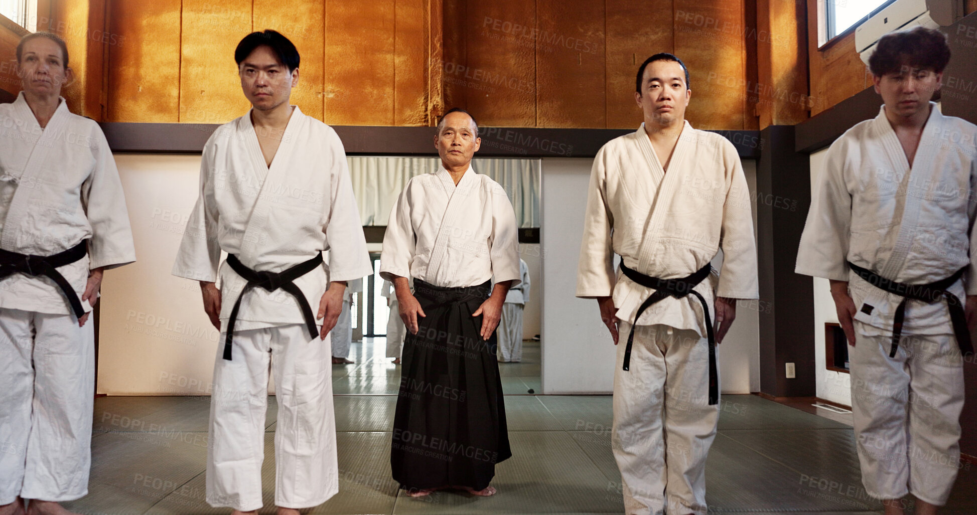Buy stock photo Japanese students, bow or learning aikido in dojo, training and modern martial arts for self defence or respect. Group, black belt class and sensei in instruction, honor and discipline in commitment