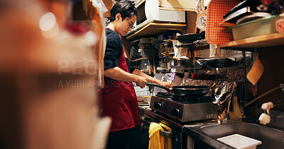 Buy stock photo Japanese chef man, stove and pan for cooking, service or catering job with heat, flame and ready. Person, restaurant or cafeteria in kitchen for meal prep, working or thinking with recipe in Tokyo