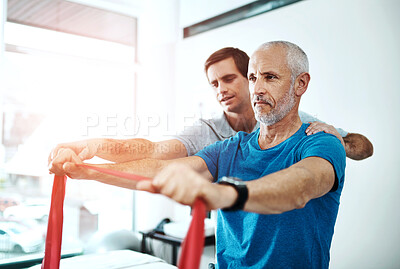 Buy stock photo Men, physiotherapy and mature patient with resistance band for stretching for rehabilitation and support on injury. People, healthcare and help for wellness or wellbeing at clinic for trust and care