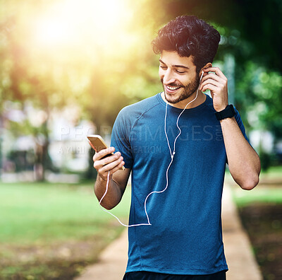 Buy stock photo Earphones, workout and man with cellphone, park and happiness with motivational podcast. Smile, streaming music or athlete with smartphone, radio and online for audio, exercise or fitness with person