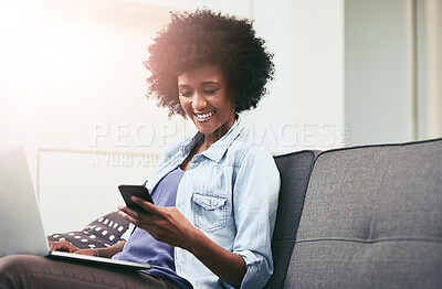 Buy stock photo African woman, phone and laptop on sofa in house for internet, networking and mobile app with smile. Technology, happy and remote work as social media manager for company, agency or business in home