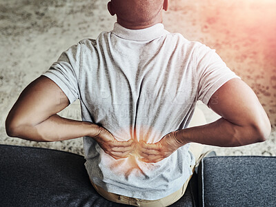 Buy stock photo Home, sofa and man holding back for pain, accident or injury with muscle sprain for scoliosis. Red glow, medical emergency and male person with spine fracture for osteoporosis in living room at house