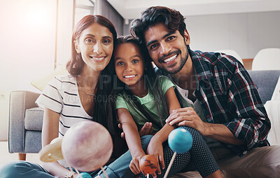 Buy stock photo Family, portrait and happy in home for relax, teaching and learning with planet models in living room. Woman, man and girl in India for development, love and bonding with smile, happiness or toys
