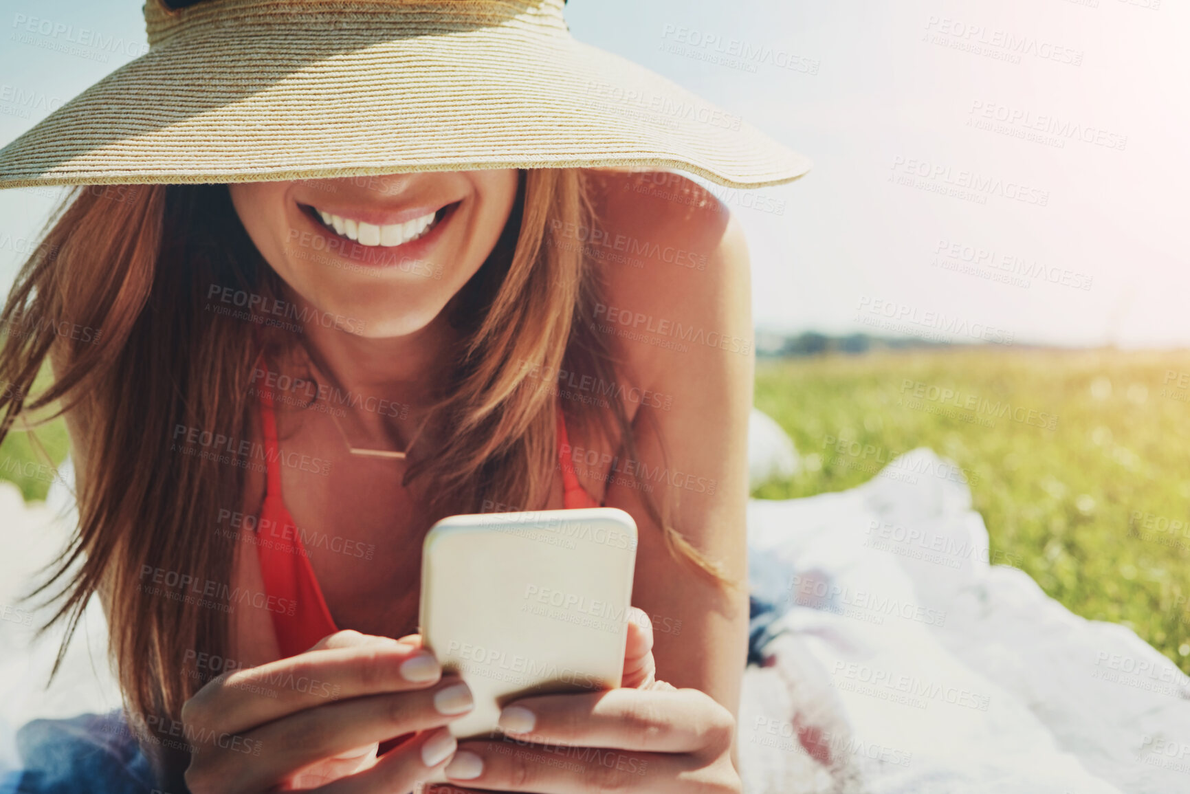 Buy stock photo Happy woman, phone and texting on blanket at park for chat, contact and scroll on web. Person, smartphone and smile on ground with mobile app, relax and picnic with post on social network in summer