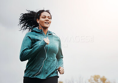 Buy stock photo Music, running and woman outdoor for fitness, jog and healthy body in winter on mockup space. Earphones, cardio and person exercise for sport, wellness or training for marathon race in nature at park