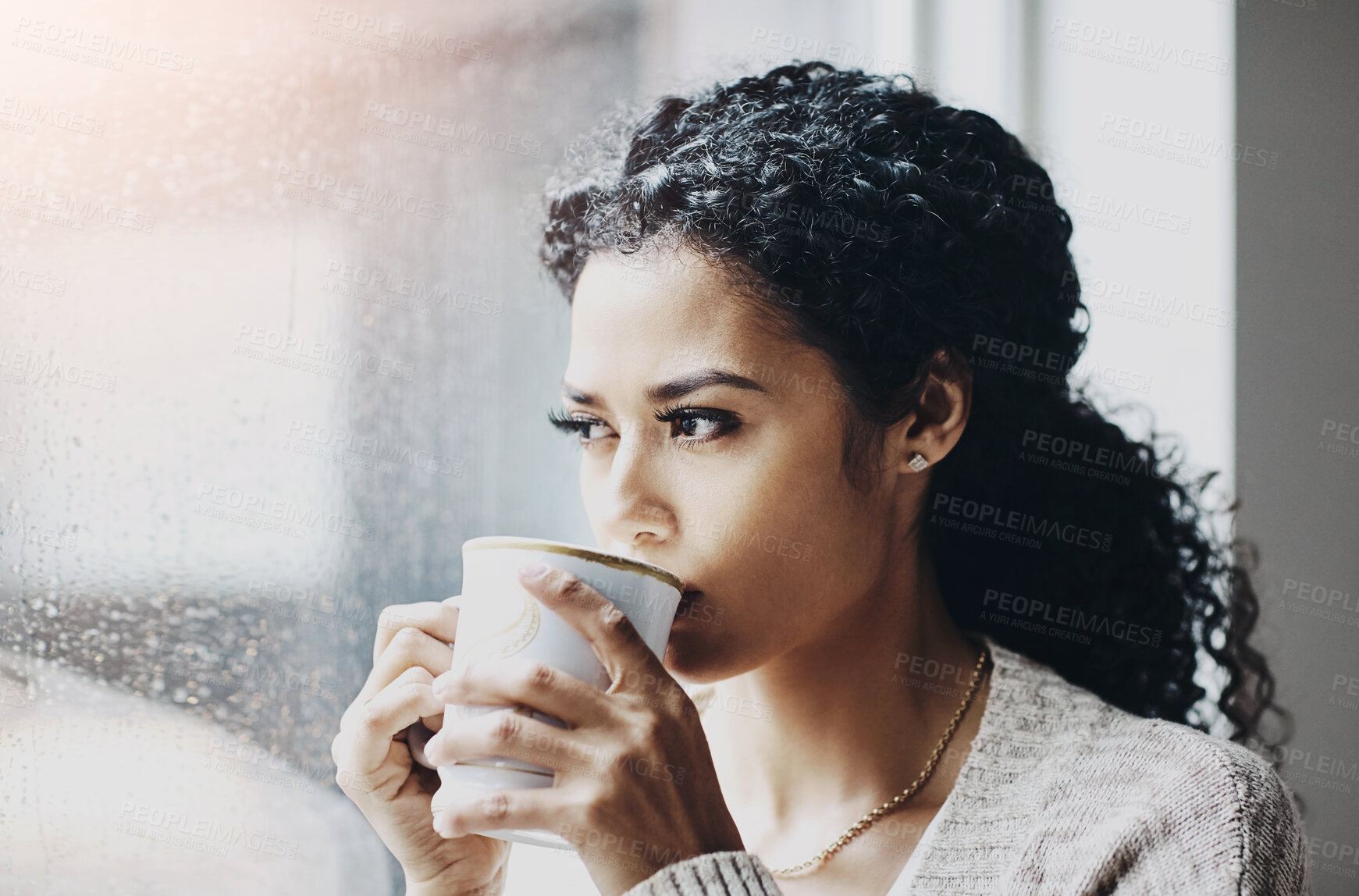 Buy stock photo Woman, coffee and thinking in home by window for relax, calm and wellness on weekend. Drinking, tea and female person with inspiration for morning, rain and peace or gratitude for health in apartment