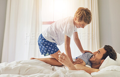 Buy stock photo Happiness, man and kid on bed for play, excited and ready for weekend at home. Dad, boy child and energy in morning for fun, bonding and game in bedroom with smile, support and love on Fathers day