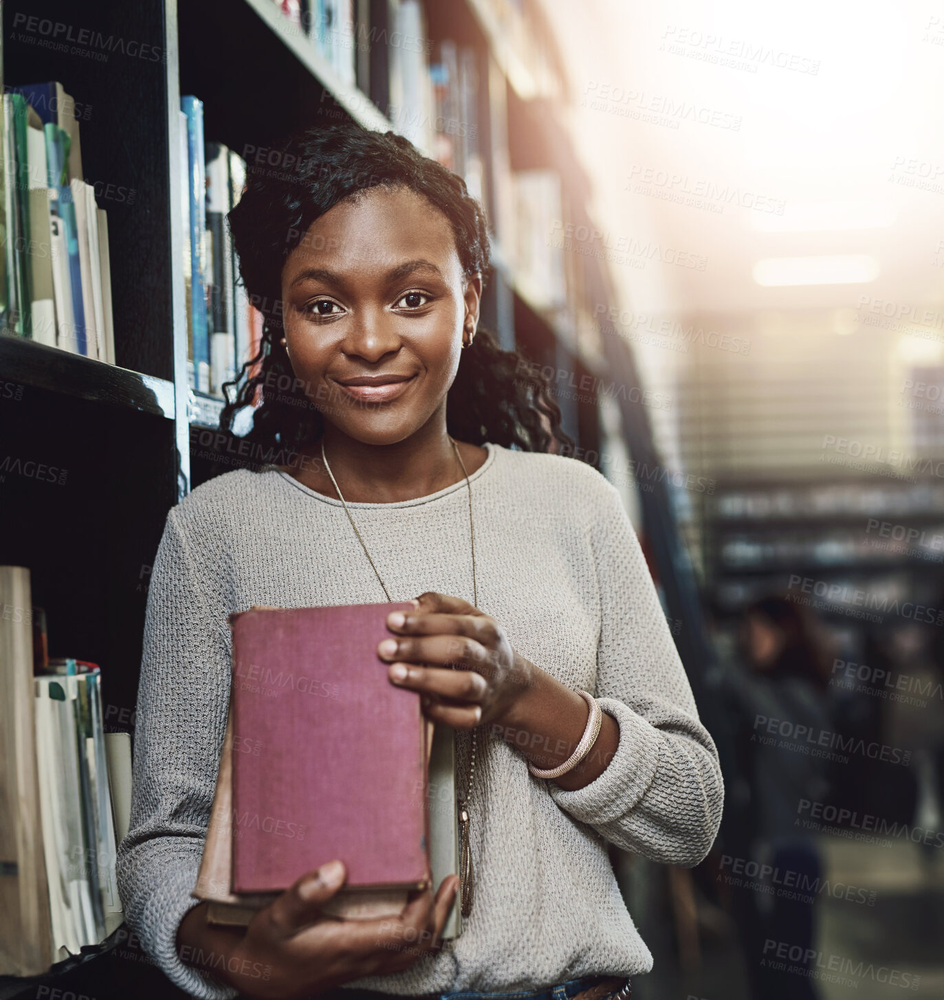 Buy stock photo University, library and portrait of black woman with books for knowledge, learning and development. Student, scholarship and shelf with study material at campus for education, information and growth