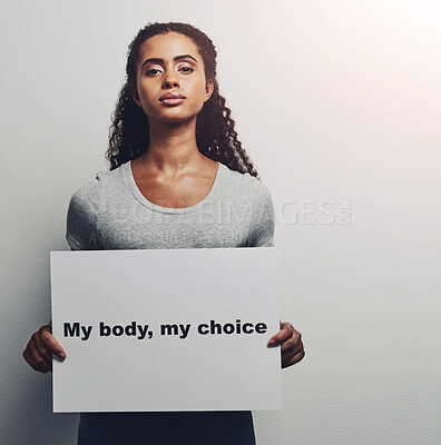 Buy stock photo Woman, portrait and protest for equality in studio with board, sign and poster for self decision or choice with advocacy . Female empowerment, girl and white background with statement for movement.