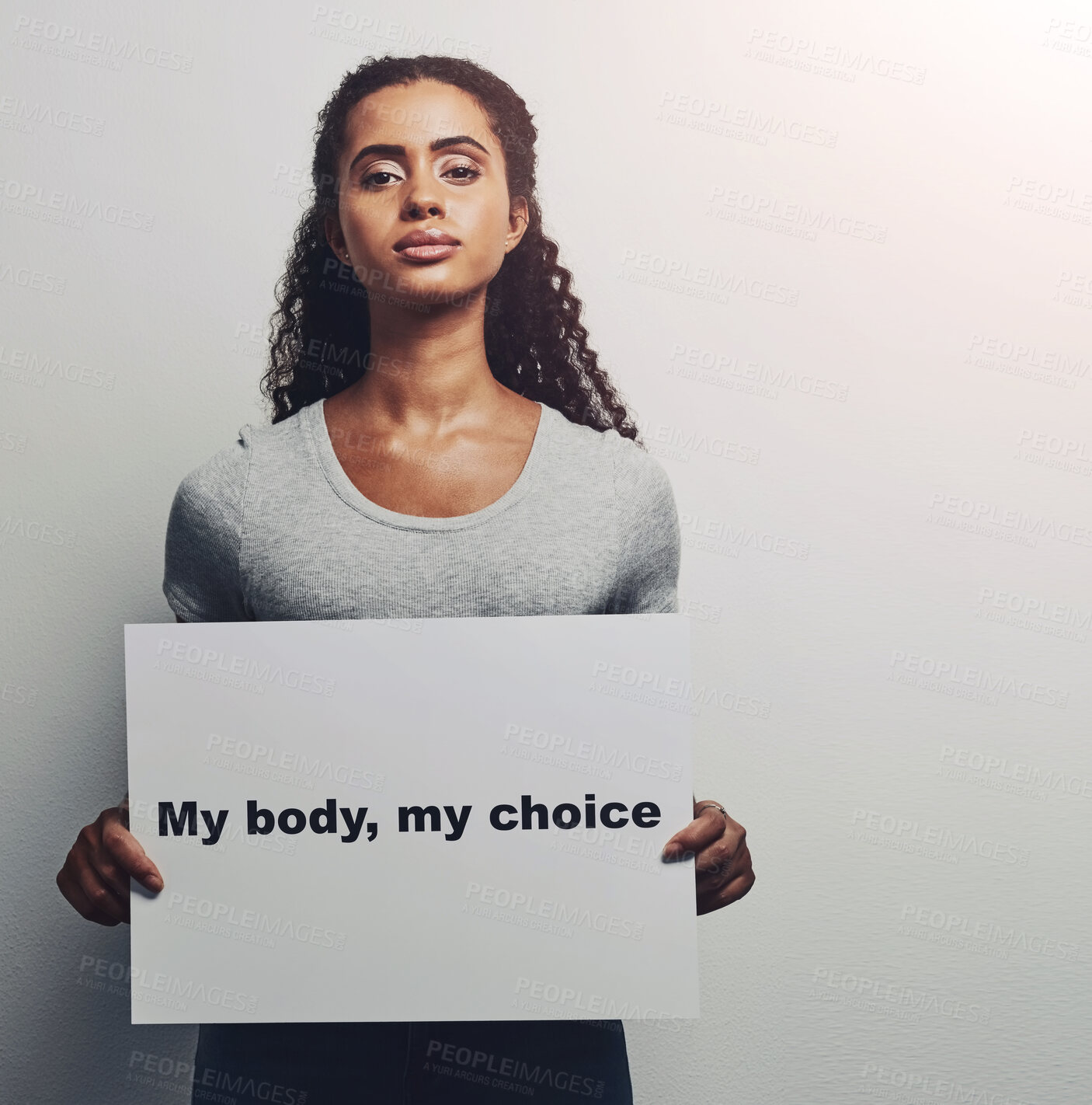 Buy stock photo Woman, portrait and protest for equality in studio with board, sign and poster for self decision or choice with advocacy . Female empowerment, girl and white background with statement for movement.