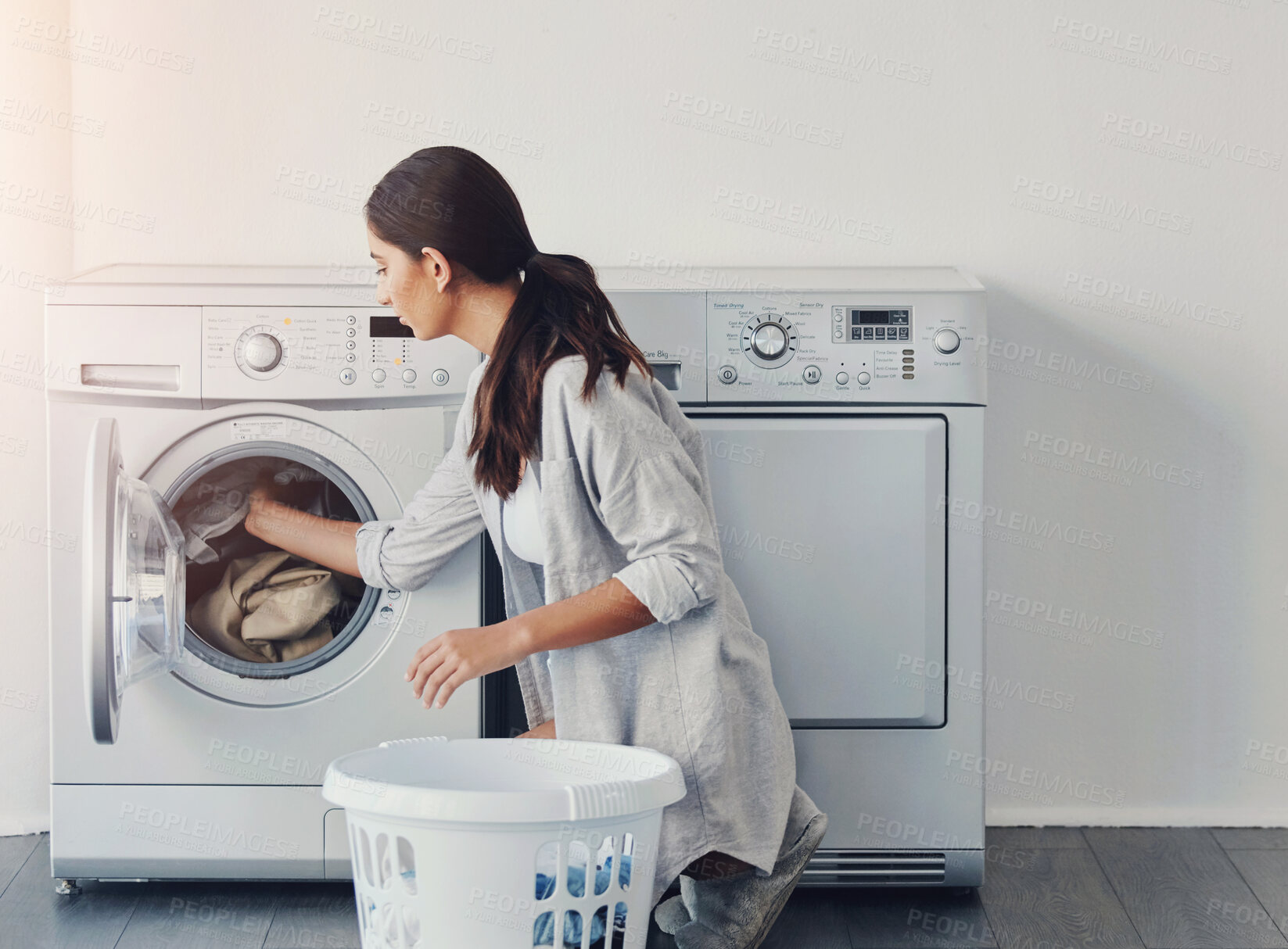 Buy stock photo Woman, basket and washing machine for laundry with dirt removal, hygiene and fabric care in home. Girl, linen container and appliance for cleaning clothes with maintenance, housekeeping and textile