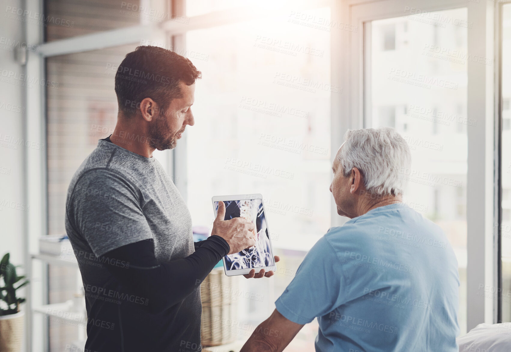 Buy stock photo Senior patient, man and tablet in physio with anatomy for joint injury, healing advice and treatment planning. Chiropractor, elderly person and digital report for physical therapy and muscle health