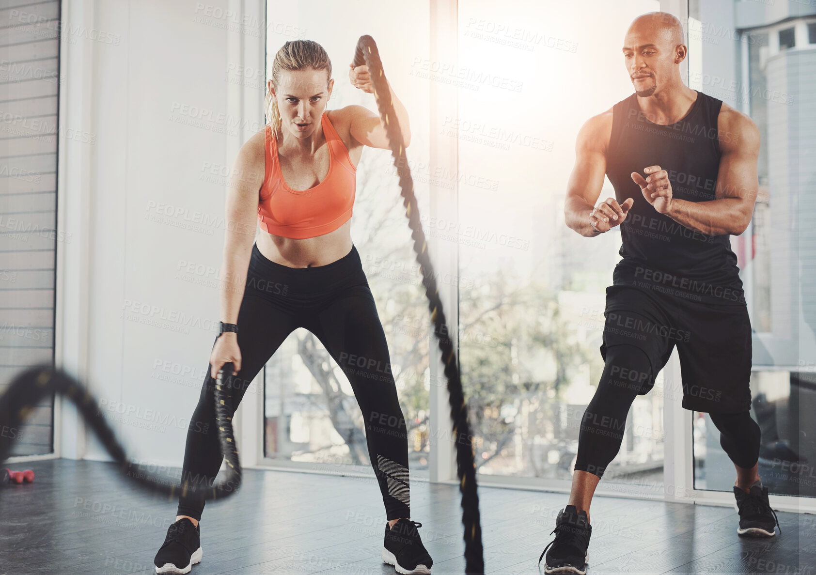 Buy stock photo Fitness, rope and people with exercise in class for muscle development, strength and support in cardio. Gym, personal trainer and woman with help for resilience, challenge and high intensity workout