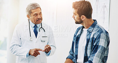 Buy stock photo Doctor, consultation and man for healthcare with patient, conversation and diagnosis in clinic. Hospital, help and communication for medicine and sick person, mature professional and medical results