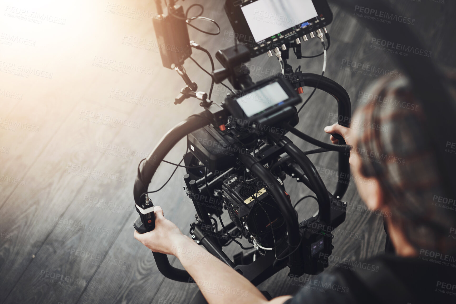 Buy stock photo Videographer, camera and man filming in studio for photography, production and media. Behind the scenes, backstage and person with stabilizing equipment on set shooting videos, documentary or film