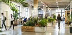 Office, busy and business people walk in startup, company and workplace with staff on computer on desk. Blur, motion and group in coworking space for rush, workflow or moving at workspace with plants