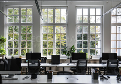 Business, office and room with computer, chair and minimal for workspace of coworking, table or startup. Workplace, interior design and architecture of building, property and decor of desk in morning