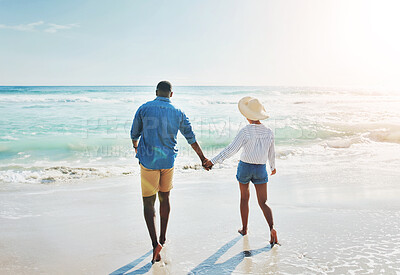 Buy stock photo Water, love and couple with holding hands at beach for outdoor adventure, travel and holiday together. Man, woman and walking with back by ocean for anniversary, support and summer vacation in Cancun