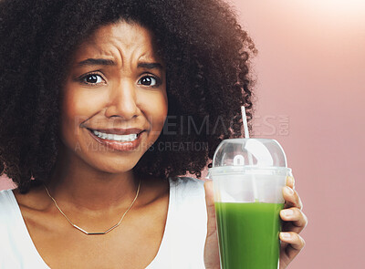 Buy stock photo Green juice, disgust and portrait of woman with diet for weight loss, health or wellness. Vitamins, gross and upset African female person with vegetable smoothie for nutrition by studio background.