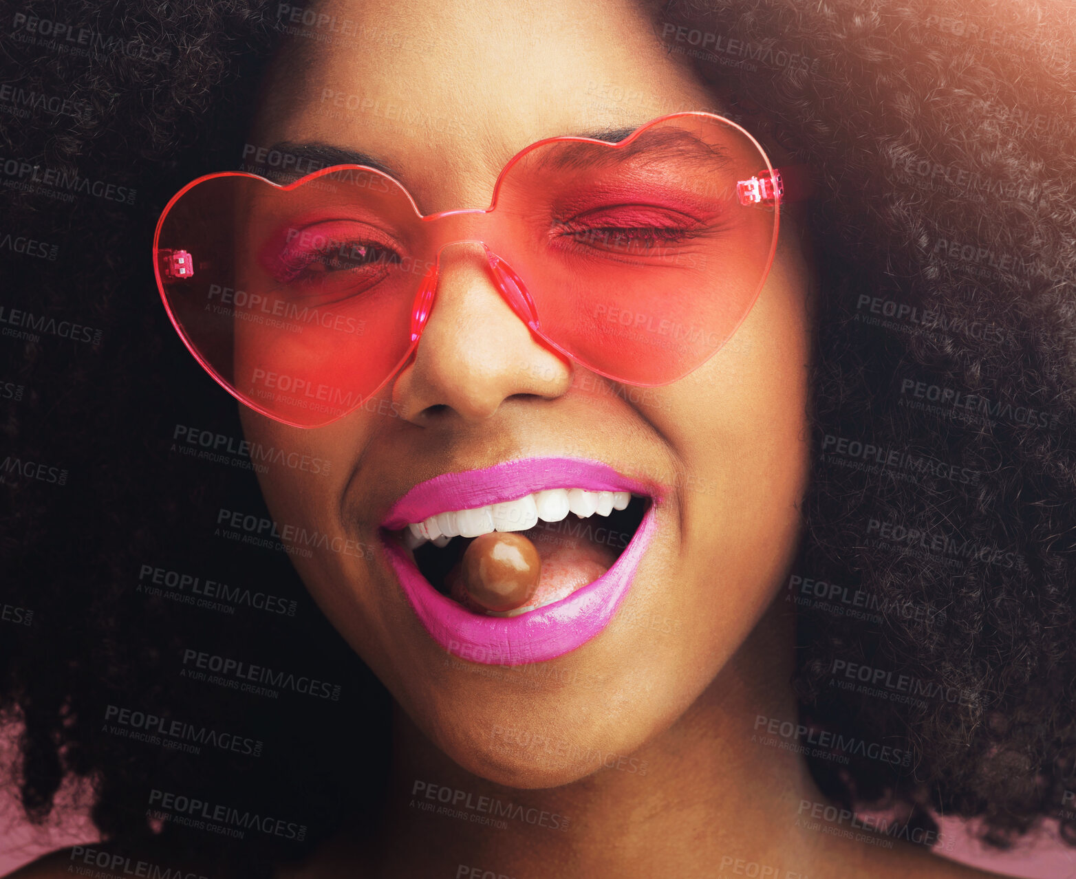 Buy stock photo Happy woman, portrait and sunglasses with makeup, chocolate or sweet candy in stylish dessert. Closeup or face of young African, female person or model with wink, cosmetics or lipstick in funky style