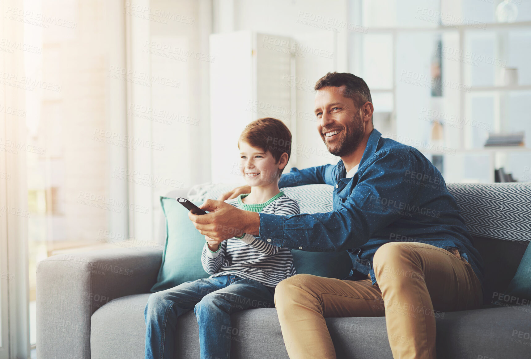 Buy stock photo Happy, man and kid with tv remote on sofa for show, entertainment and watching cartoon together. Family, father and son with smile in living room for love, care and streaming of channel at home