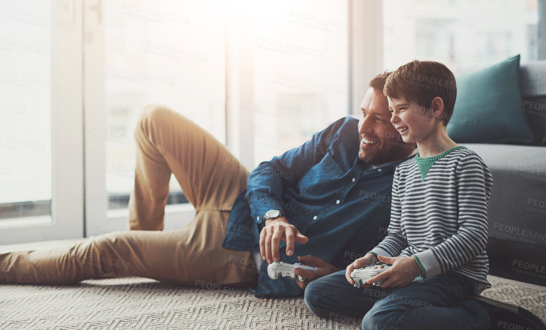Buy stock photo Dad, relax and playing games with child on console for entertainment or bonding on floor at home. Father, son or kid with smile and enjoying esports or fun together on carpet with controller at house