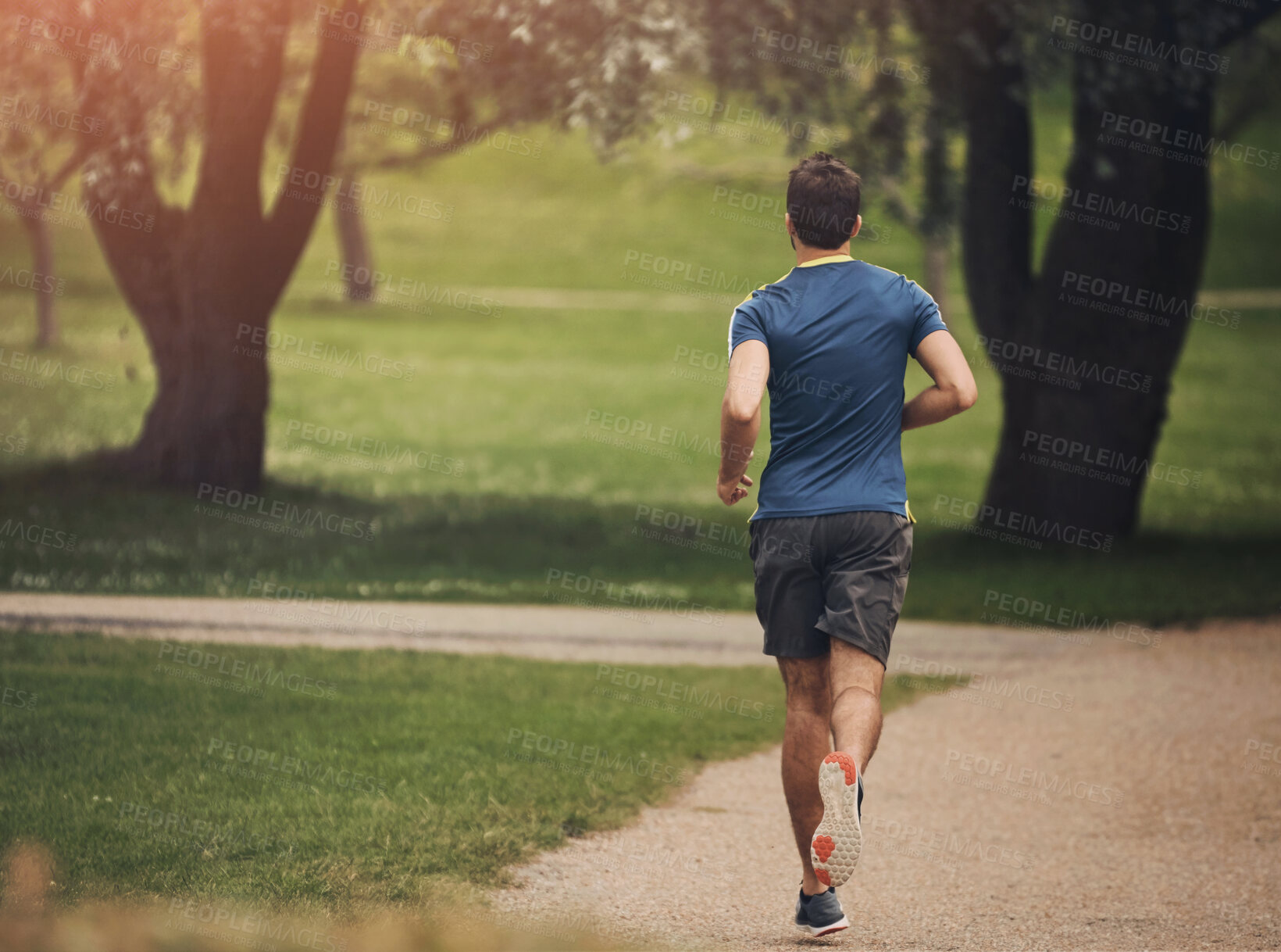 Buy stock photo Running, back and man in park for fitness, cardio and exercise on pathway. Male athlete, jogging and training in nature for energy, marathon challenge and healthy lifestyle or aerobic activity