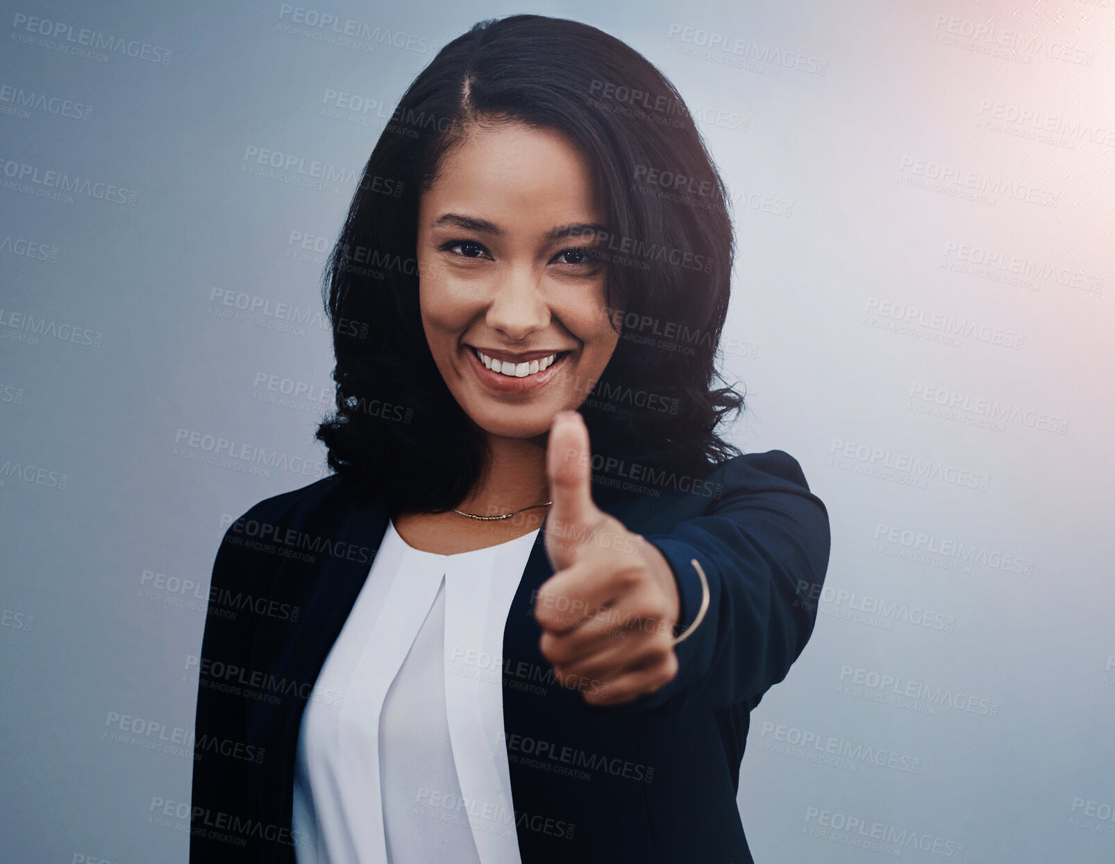 Buy stock photo Happy, business woman and portrait with thumbs up for winning, good job or success on a blue studio background. Female person or employee with smile, like emoji or yes sign for well done or thank you