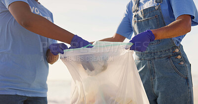 Buy stock photo Volunteer, beach and trash bag for cleaning environment as community service or pollution, plastic or waste management. People, climate change and ocean for eco recycling, global warming or teamwork